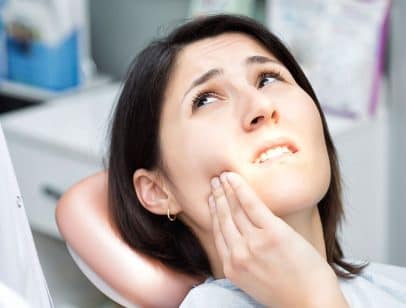 Woman suffering from Dental Implant Complications {{brizy_dc_image_alt entityId=